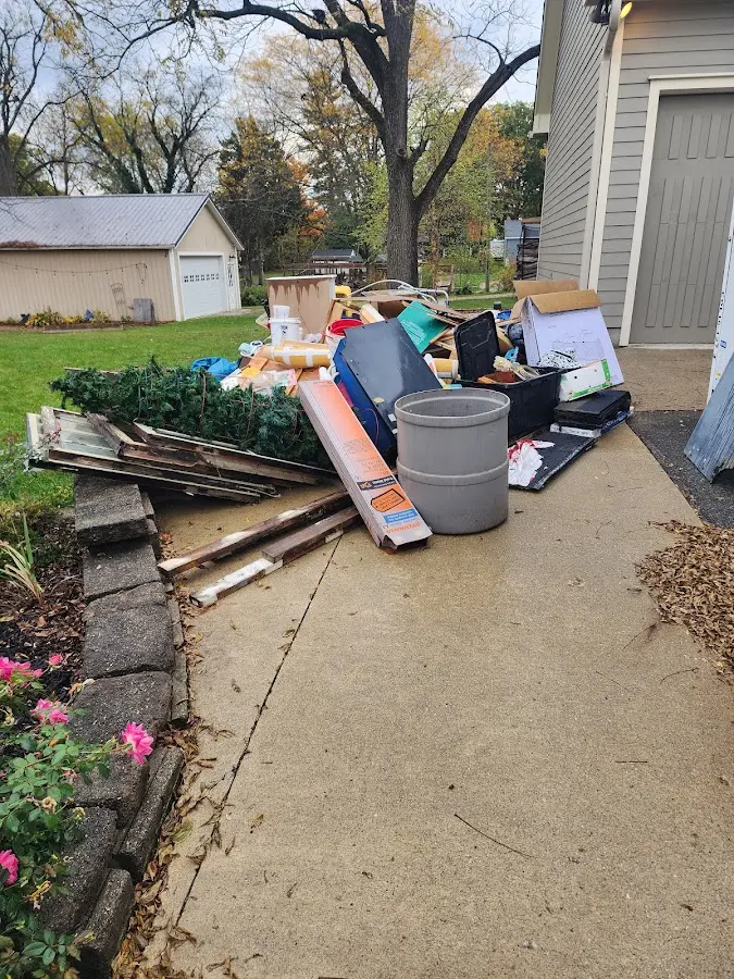 Dumpster being loaded with debris for Roofing Dumpster Rental in Auburn